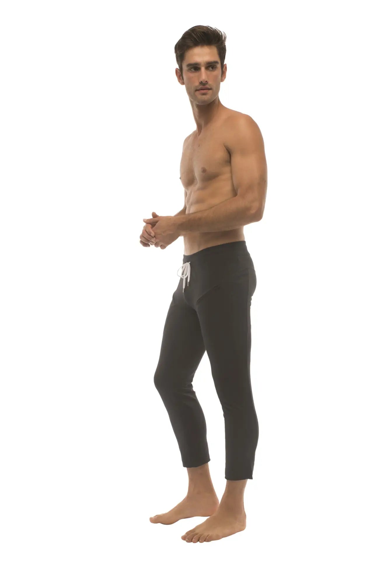 Mens solid black 45 zipper pocket capri yoga pants with a white drawstring waistband and cropped length