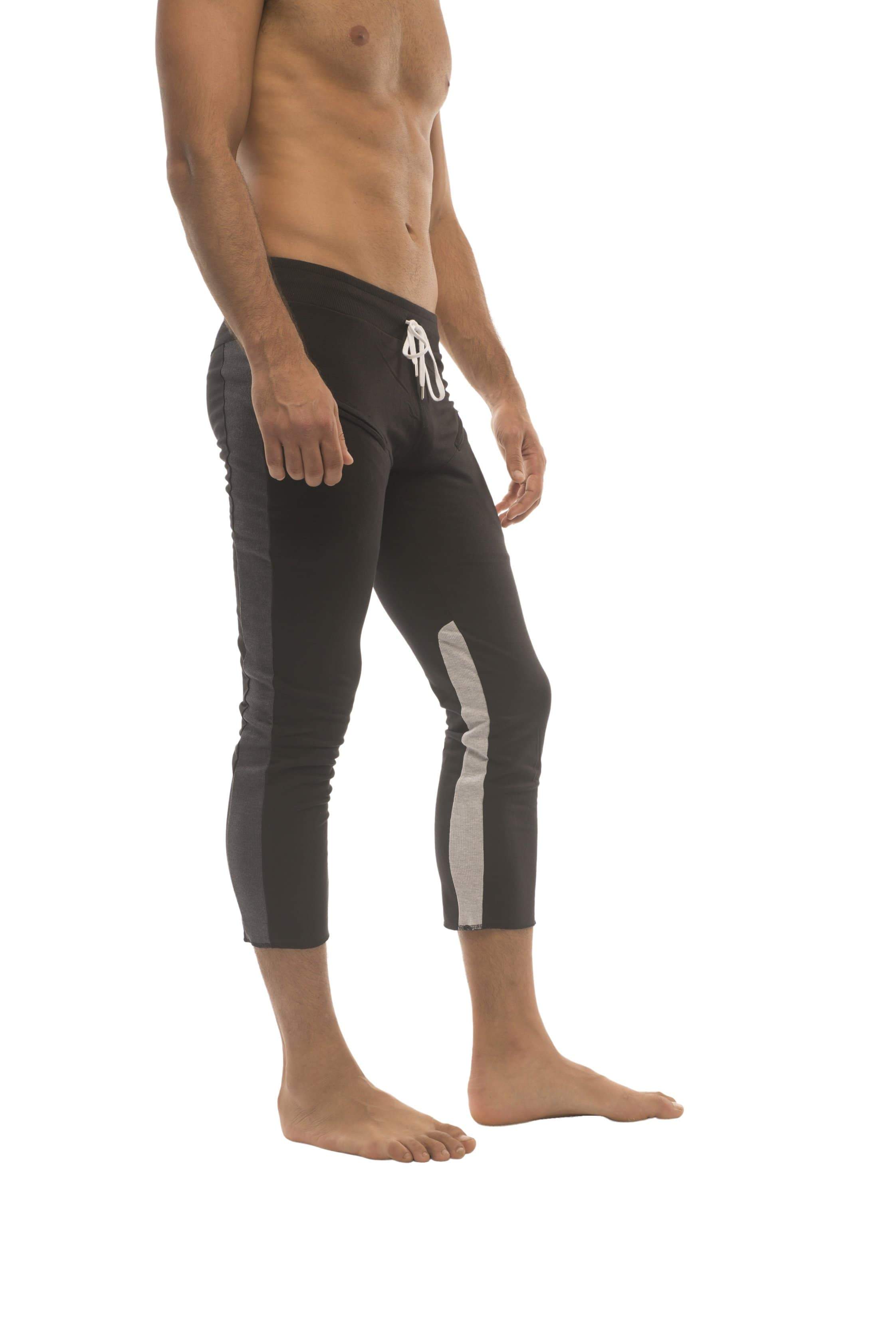 Mens black capri-length swim trunks with gray side panels and a white logo on the waistband for active wear