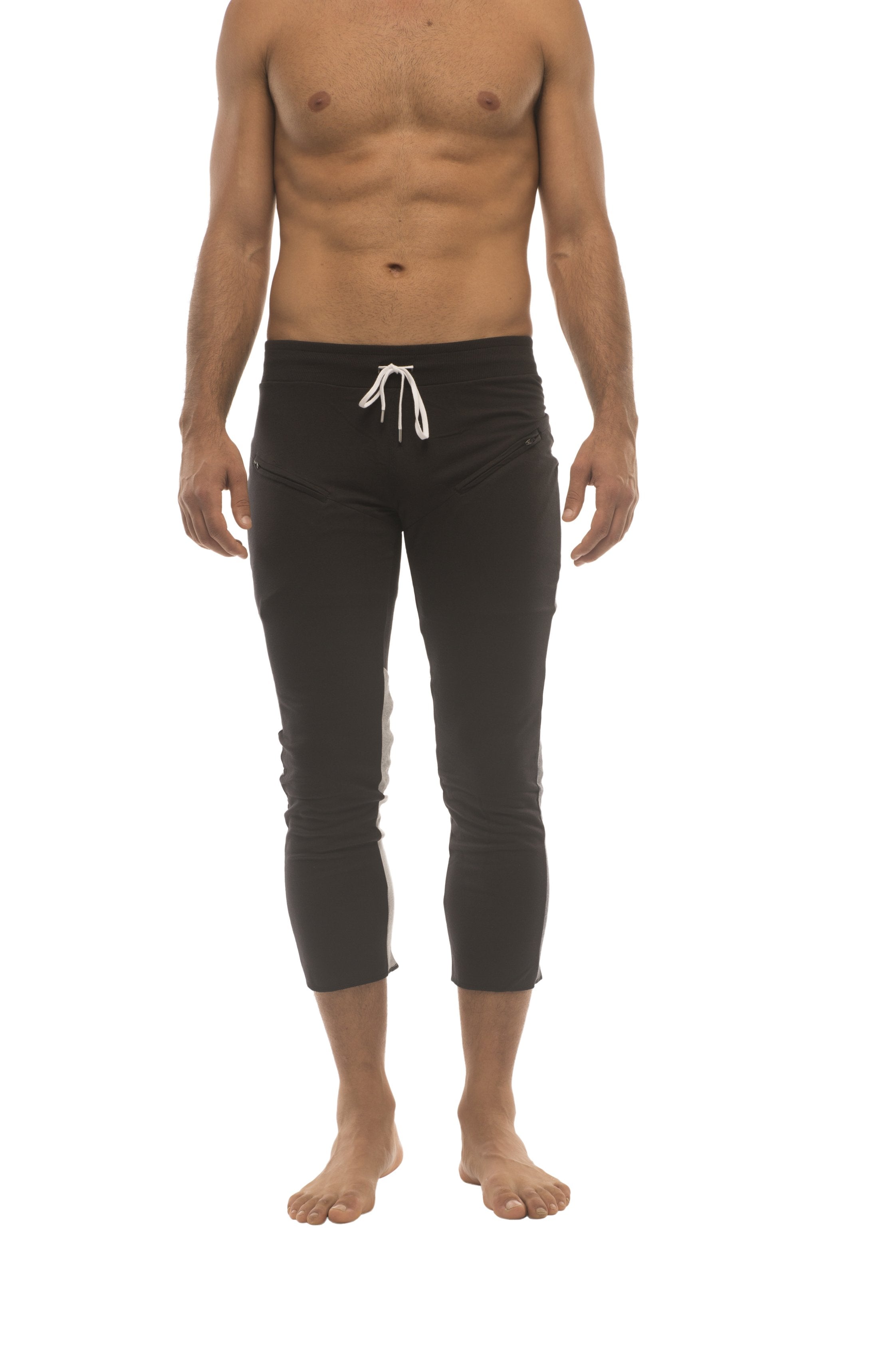 Mens black capri yoga pants with white drawstring waistband and subtle charcoal and grey side stripes
