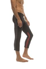 Mens black capri yoga pants with red side stripe white drawstring waistband and zipper pockets for active wear