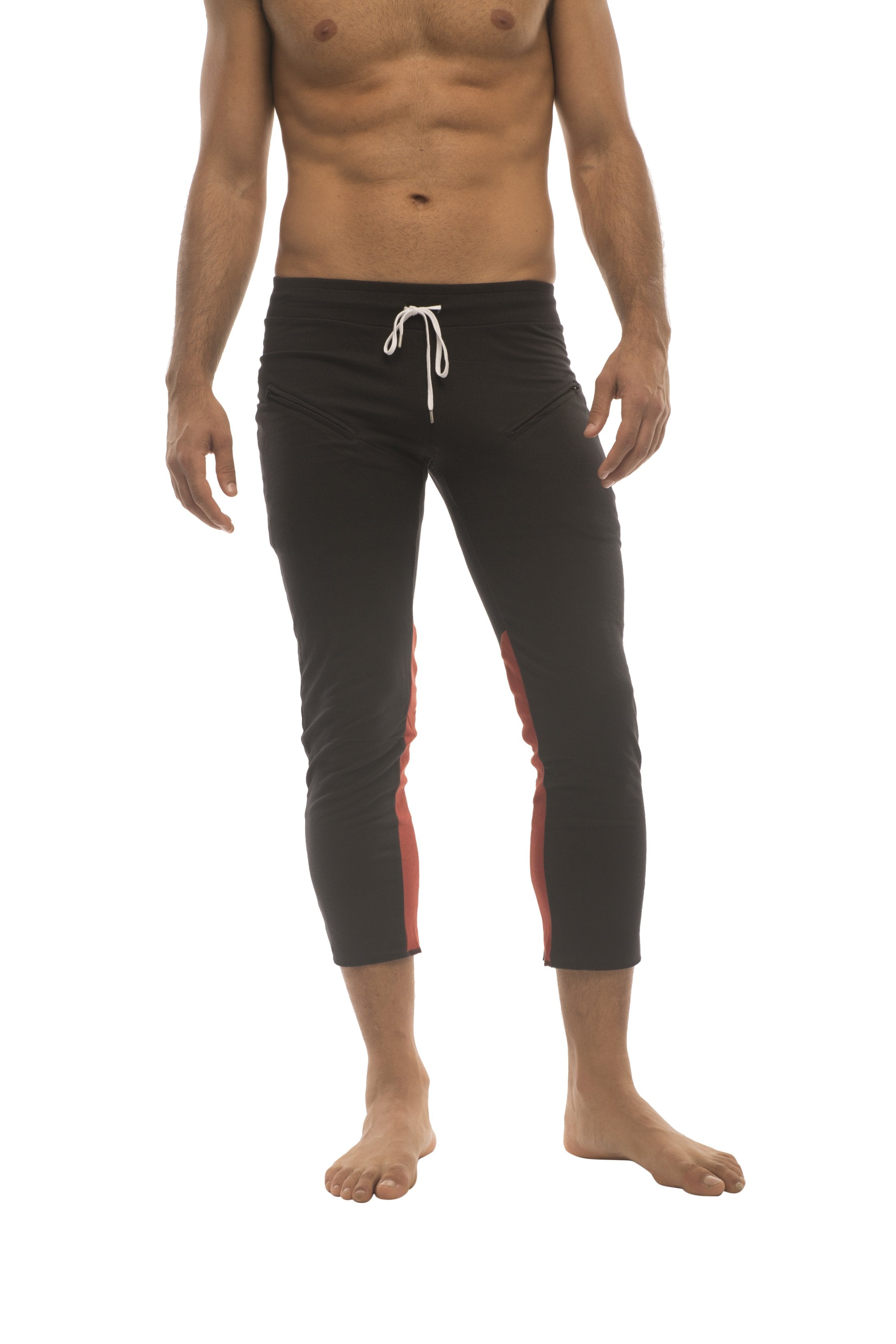 Mens black capri swim trunks with red side panels and white drawstring waistband for active wear