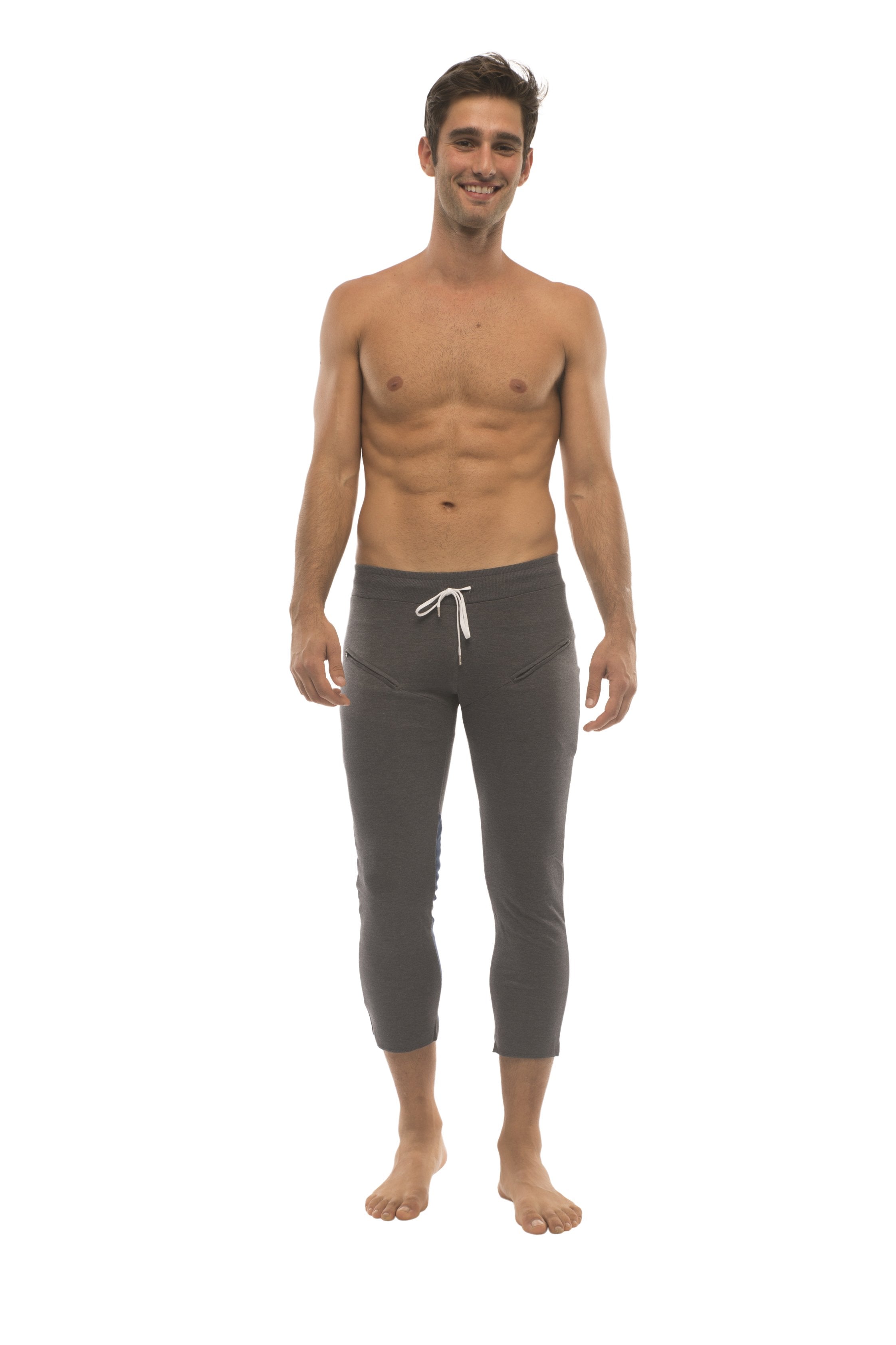 Mens charcoal capri yoga pants with white drawstring waistband featuring zipper pockets for secure storage