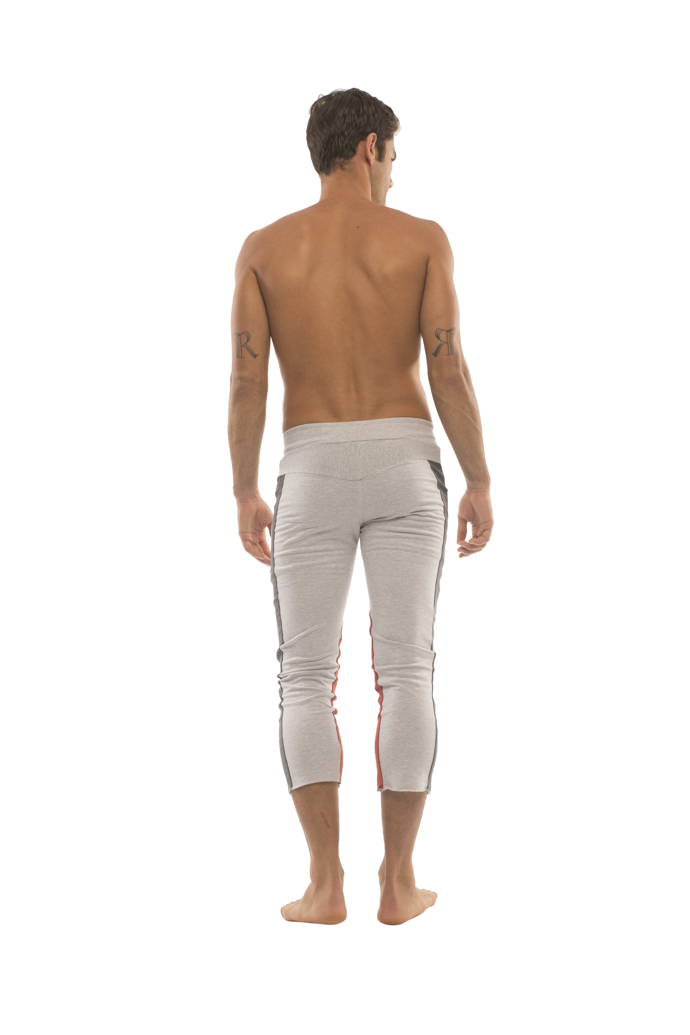 Mens white athletic capri pants with black and red side stripes designed for yoga and casual wear
