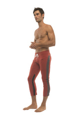 Mens red 4/5 zipper pocket capri yoga pants with dark gray side stripes and white drawstring waistband