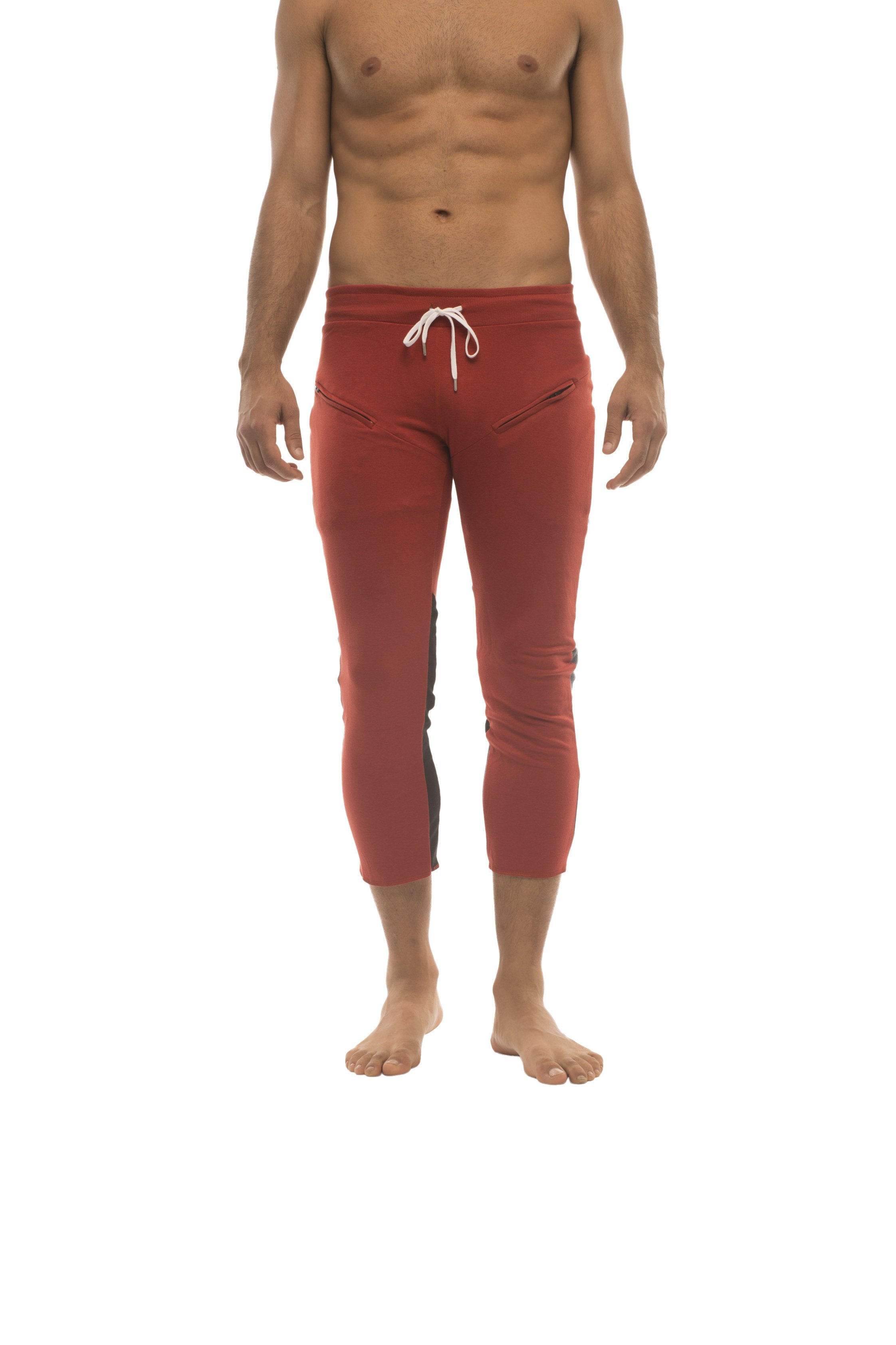 Mens red capri yoga pants with white drawstring waistband and black side panels for athletic use