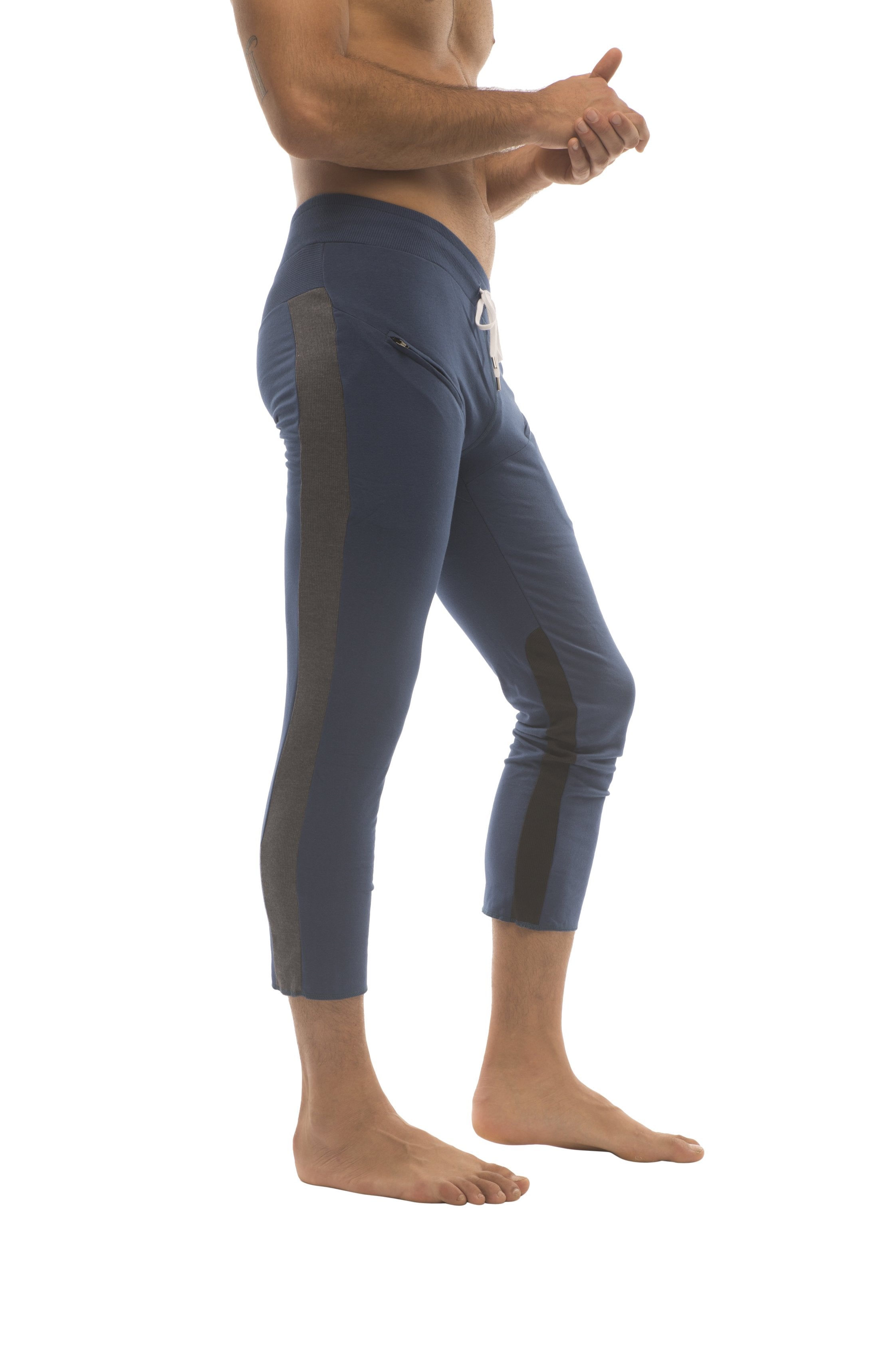 Mens navy blue athletic capri yoga pants with black side panels and white drawstring waistband with zipper pockets
