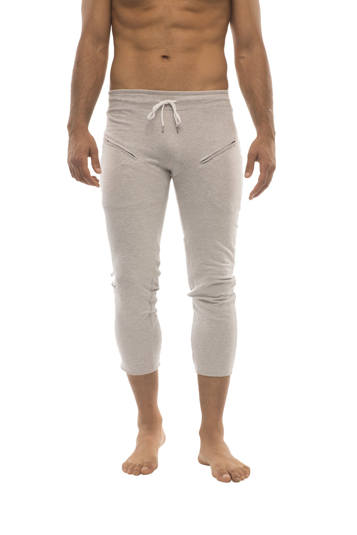 Light gray cropped men’s capri yoga pants with a drawstring waist and side zipper pockets in solid heather grey