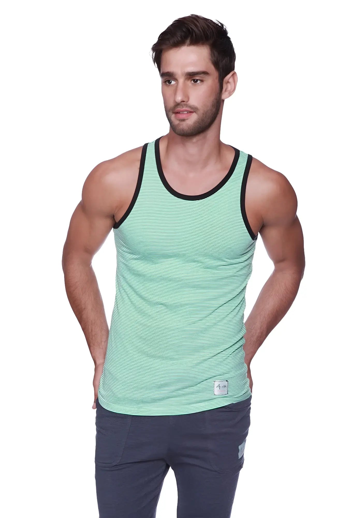 A men’s mint green and black striped tank top with a ribbed neckline paired with black and green cuffed yoga pants