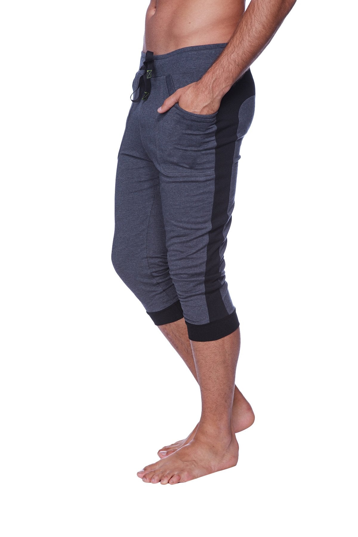 Mens cuffed yoga pants in charcoal with black side panels featuring elastic cuffs and capri-length design