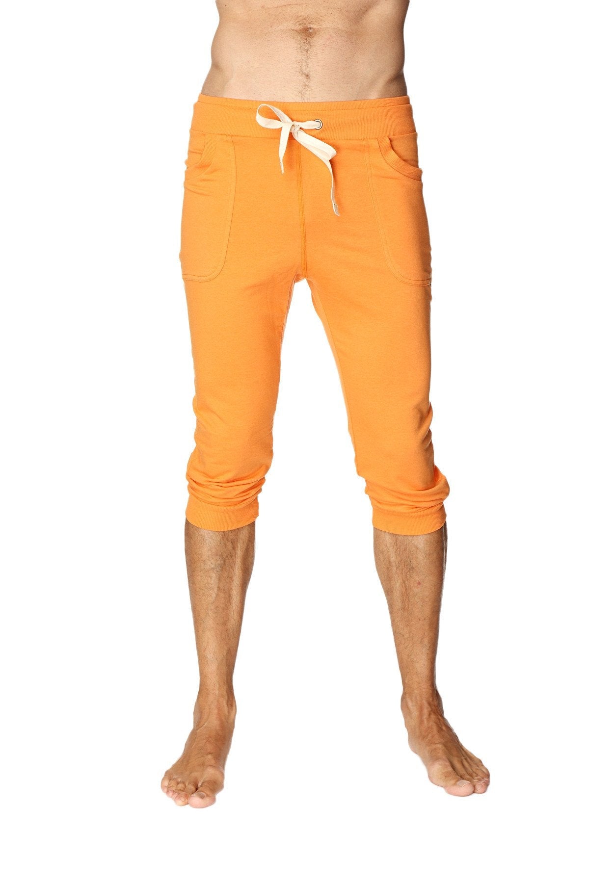 Mens cuffed yoga pants in solid sun orange with bright orange cropped jogger style, white drawstring waistband and side pockets