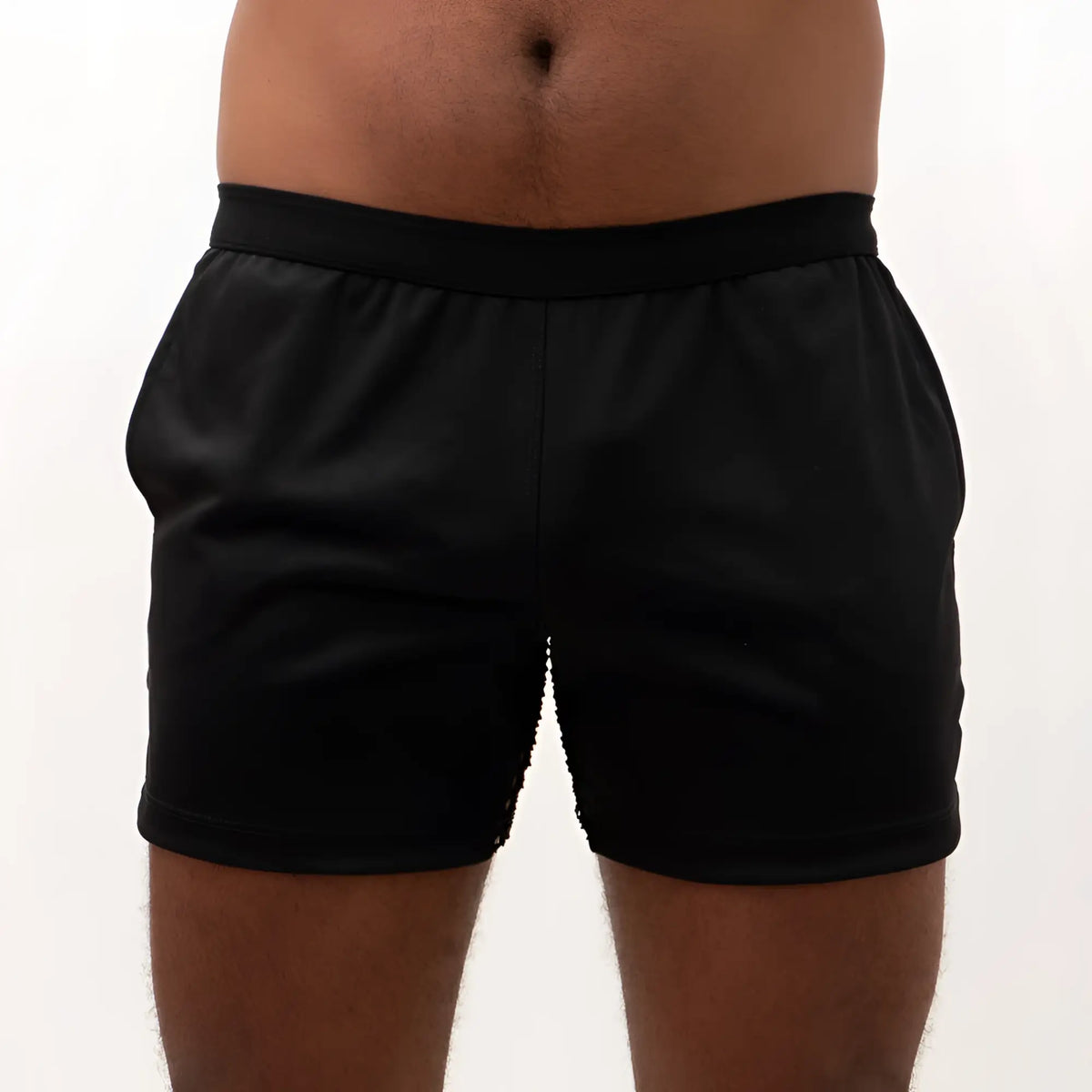Black mesh back short with smooth stretchy fabric and elastic waistband shown from the back side