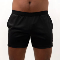 Black mesh back short with smooth stretchy fabric and elastic waistband shown from the back side