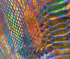Metallic snake pocket shorts in iridescent holographic fabric with shimmering scale pattern in vibrant rainbow hues