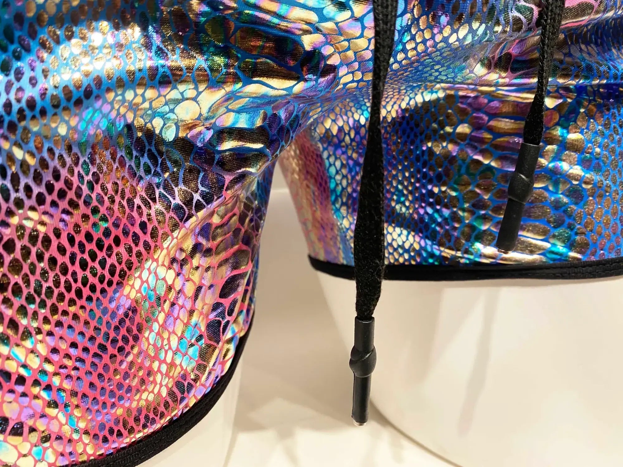 Metallic snake pocket shorts with iridescent snake scale pattern and black drawstrings for casual wear