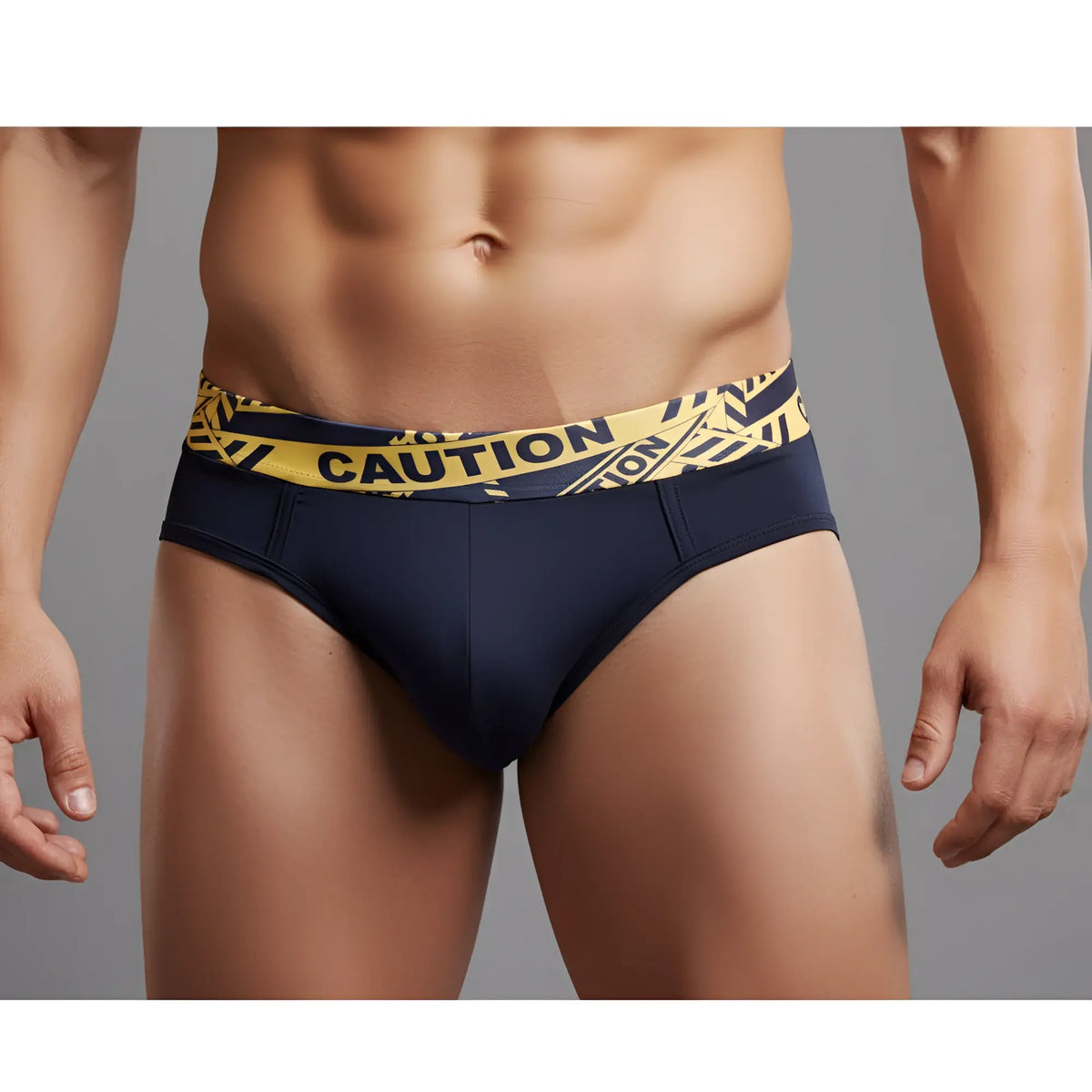 Navy blue briefs with yellow and black caution tape patterned waistband from metromalewear caution brief 5203-60