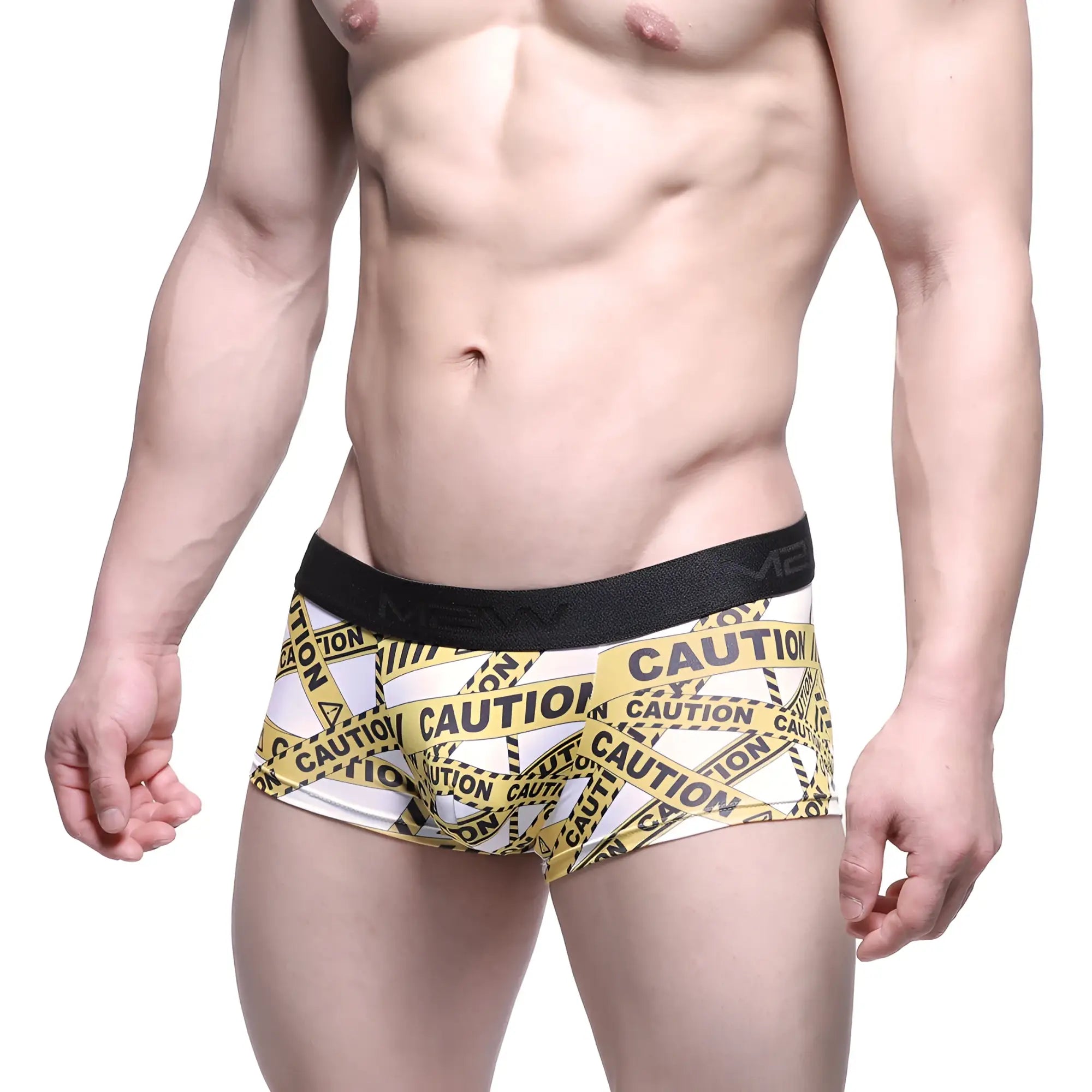 White boxer briefs with bold yellow and black caution tape pattern and solid black elastic waistband by metamalewear