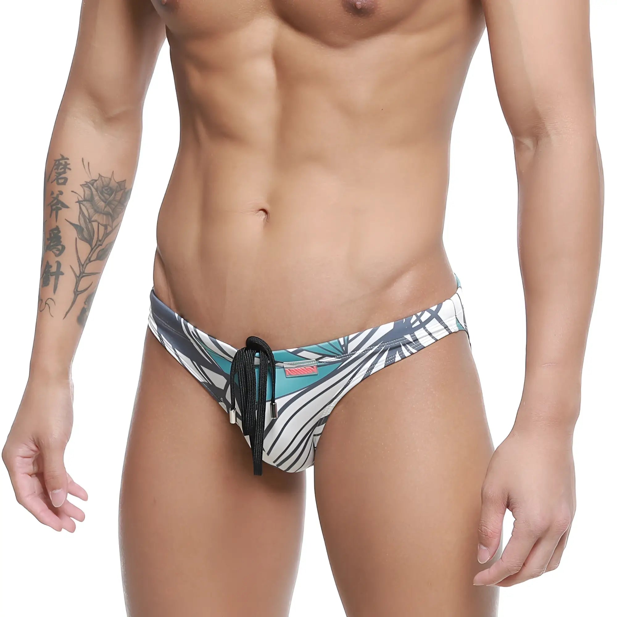 MetroMaleWear classic men’s swim trunks with bold teal black and white tropical leaf pattern and black drawstring