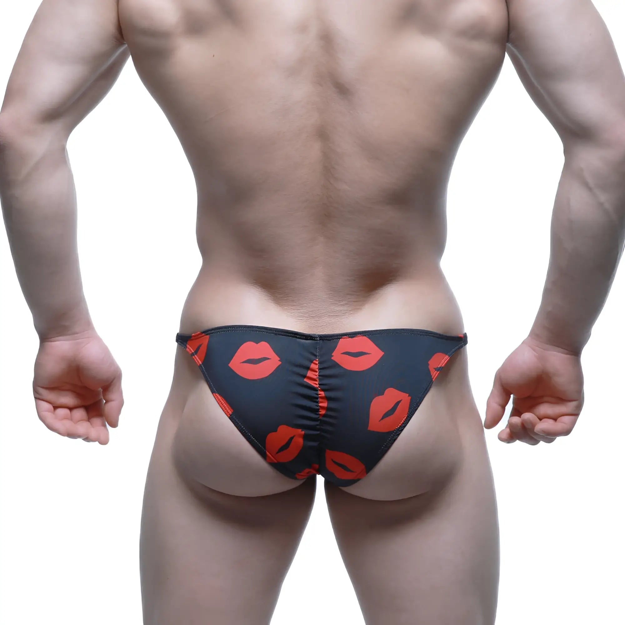Black swim trunks by MetroMaleWear featuring a bold red lipstick print pattern for a stylish beach look