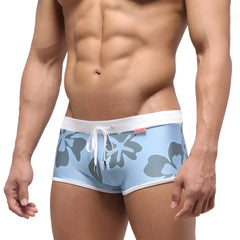 Light blue metro male wear fresco swim trunk with gray floral pattern white trim and drawstring waistband