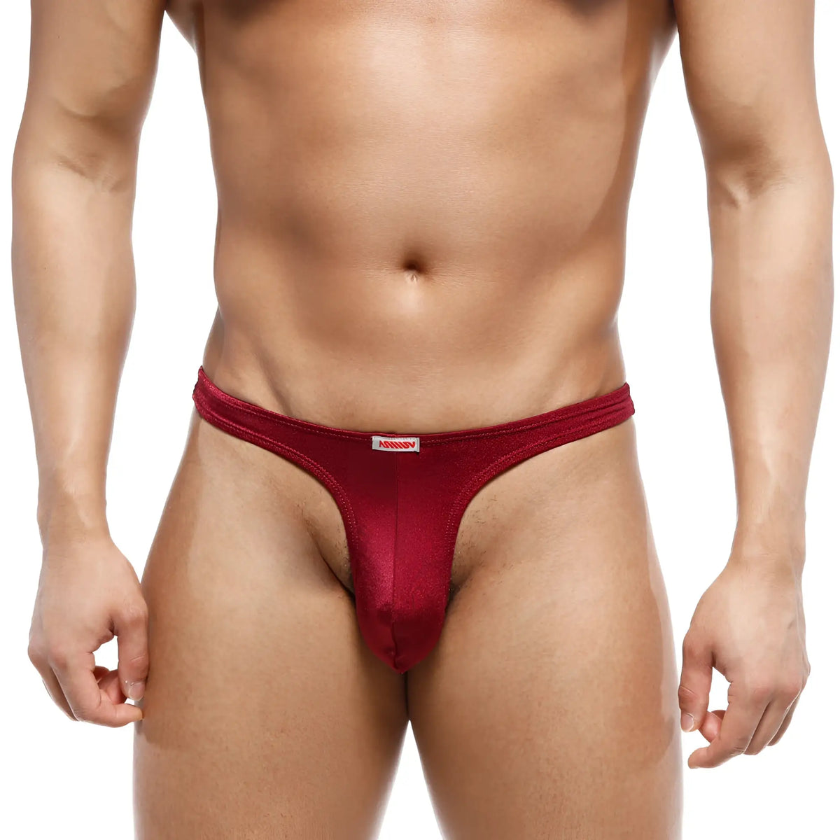 A sleek deep red mens thong from MetroMaleWear made of smooth stretchy fabric with a small white brand tag