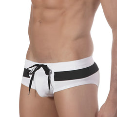 White swim trunks by metromalewear with a bold black waistband stripe and matching black drawstring for beachwear