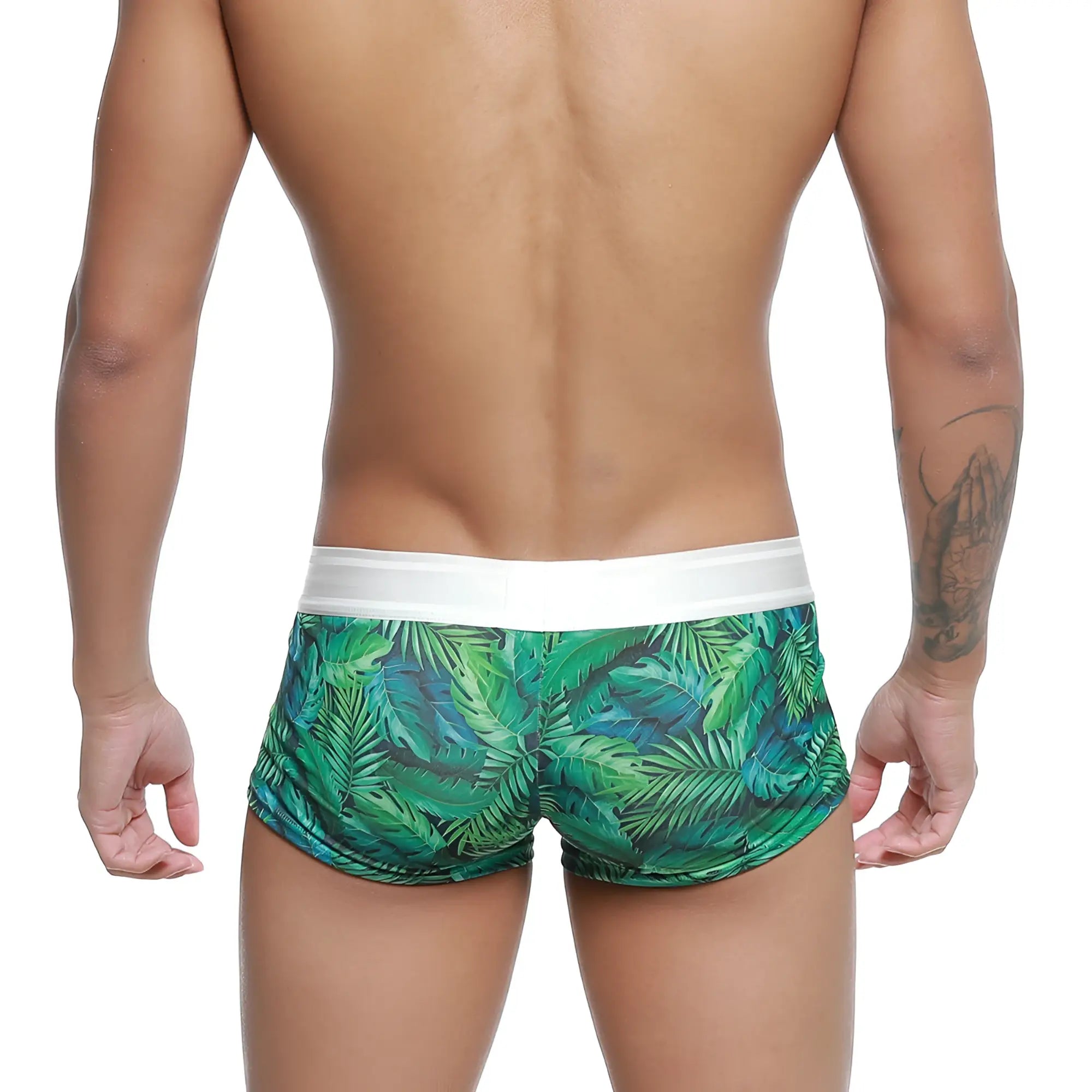 Green tropical leaf-patterned swim trunks with white elastic waistband from metromalewear jungle trunk 2026-08