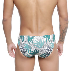 White swim trunks with vibrant teal and dark gray tropical leaf pattern metroMalewear Meadow Bikini 5103-56