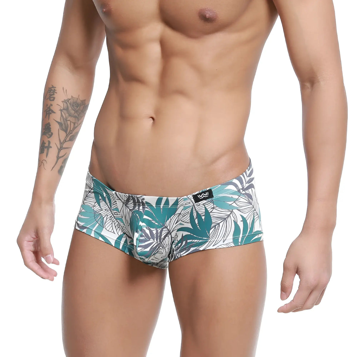 White briefs by MetroMaleWear Meadow Trunk 2125-56 with vibrant teal and gray tropical leaves and black logo waistband
