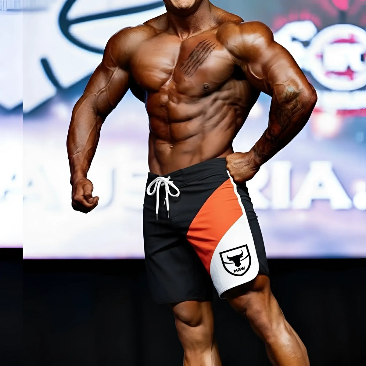 MetroMaleWear MetroMuscleWear IFBB Pro mens physique board short in black orange and white with white drawstring and bull logo