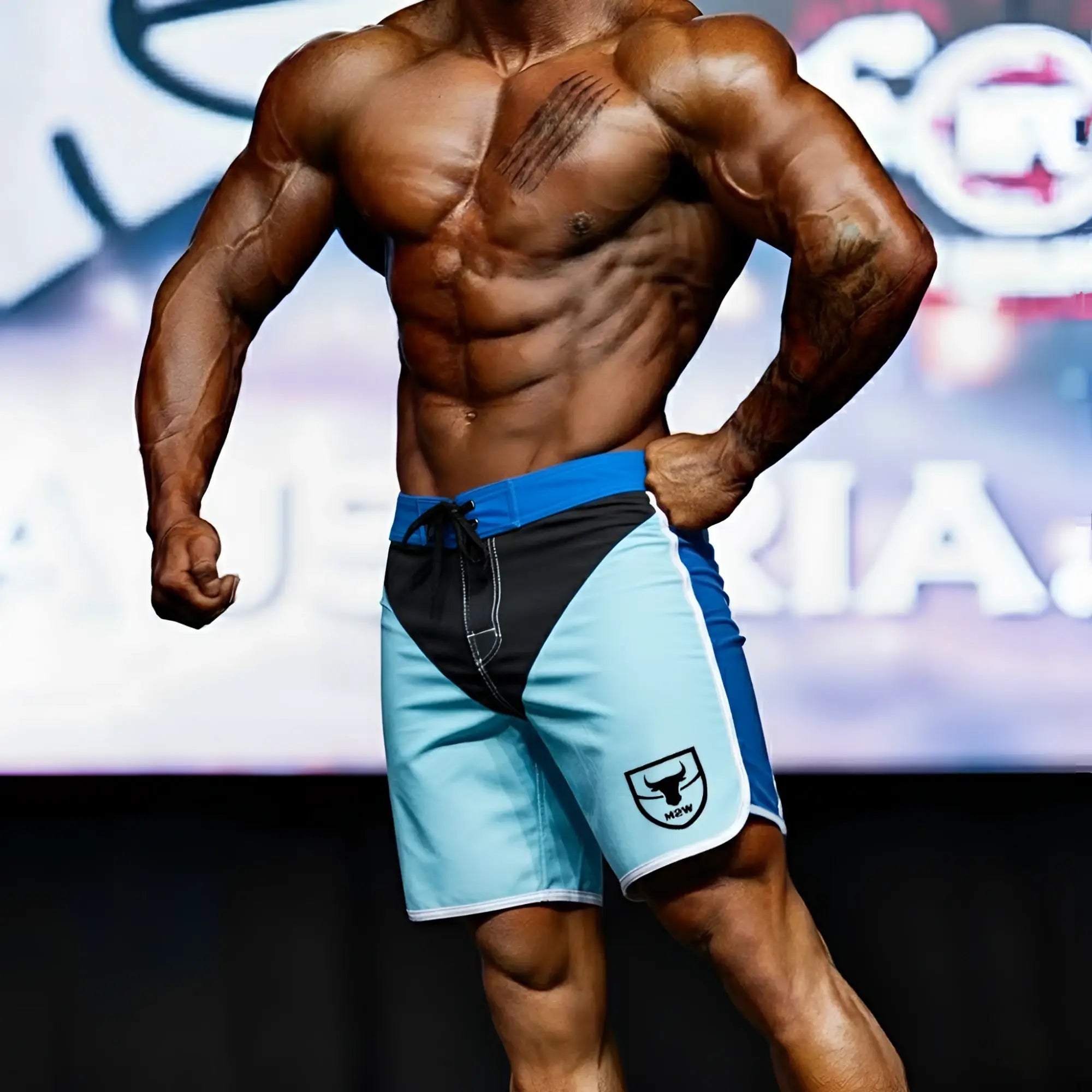 MetroMaleWear MetroMuscleWear IFBB Pro mens physique board shorts in blue and black with white logo on lower right leg
