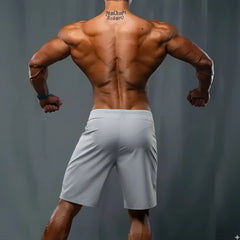 Light gray metroMuscleWear athletic shorts with subtle waistband logo designed for metroMaleWear mark physique board short use