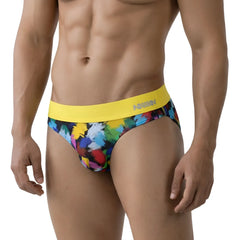 Vibrant abstract paint-splatter briefs with a bold yellow waistband featuring the annn logo from MetroMaleWear
