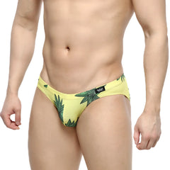 Yellow swim trunks with green leaf pattern and black waistband logo from metromalewear palmera bikini 5103-37