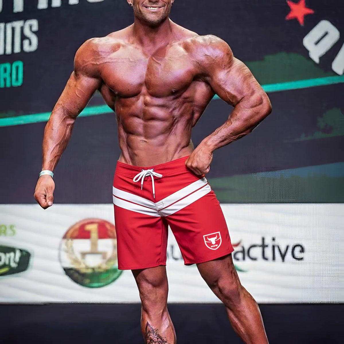 Red athletic shorts with white stripes and small bull logo on left leg from metromalewear physique board short crimson 4706-13