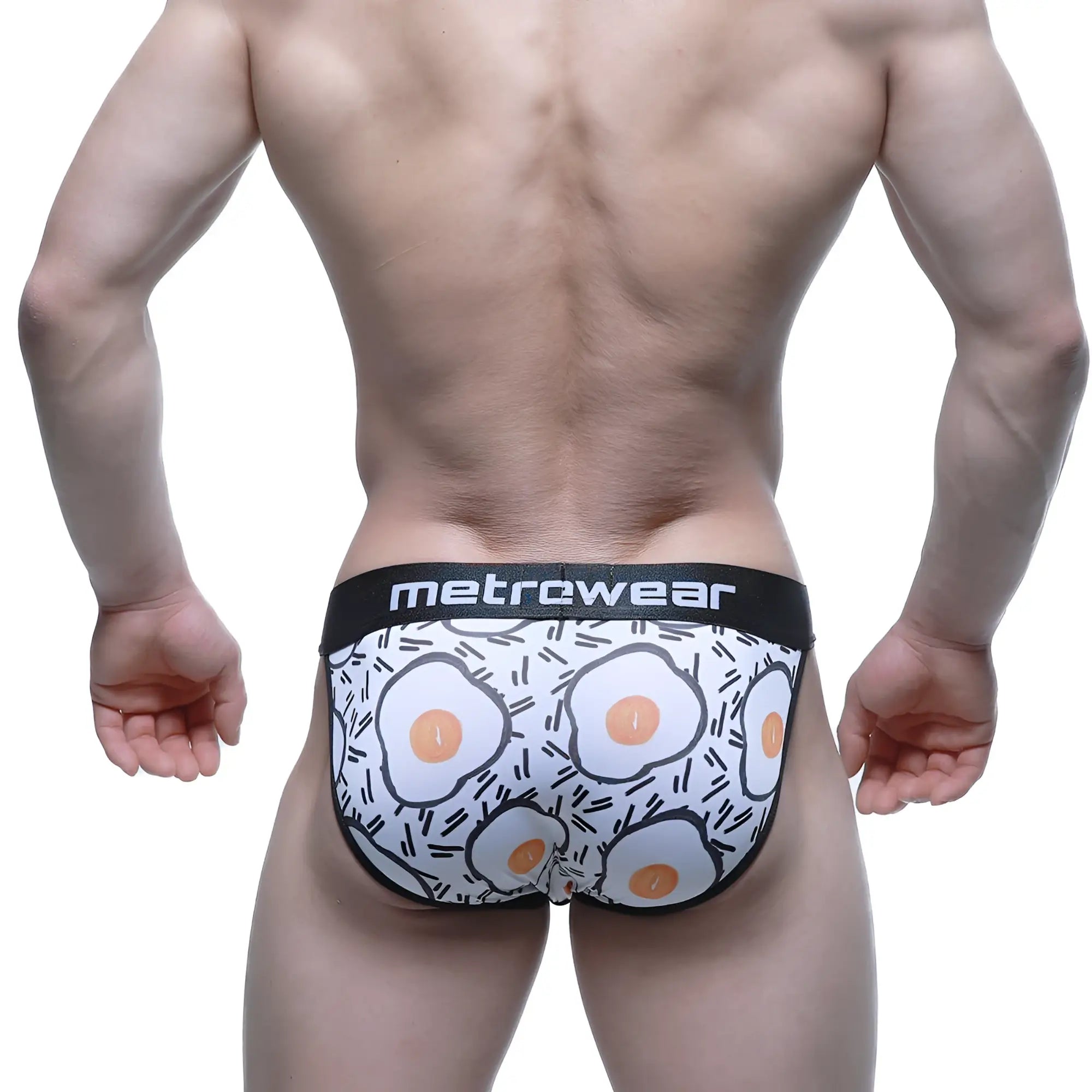 White men’s briefs with playful fried egg pattern black trim and metrcwear brand on waistband metro male wear sunny side bikini