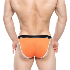 Bright orange MetroMaleWear Tomcat bikini briefs with black waistband and white trim designed for athletic use