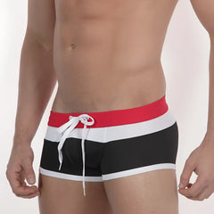 Black MetroMaleWear Trio swim trunks with bold red white and black stripes and matching drawstring waistband