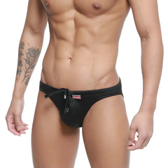 Black satin swim trunks with drawstring waistband and small red logo on the side from metromalewear vanguard collection