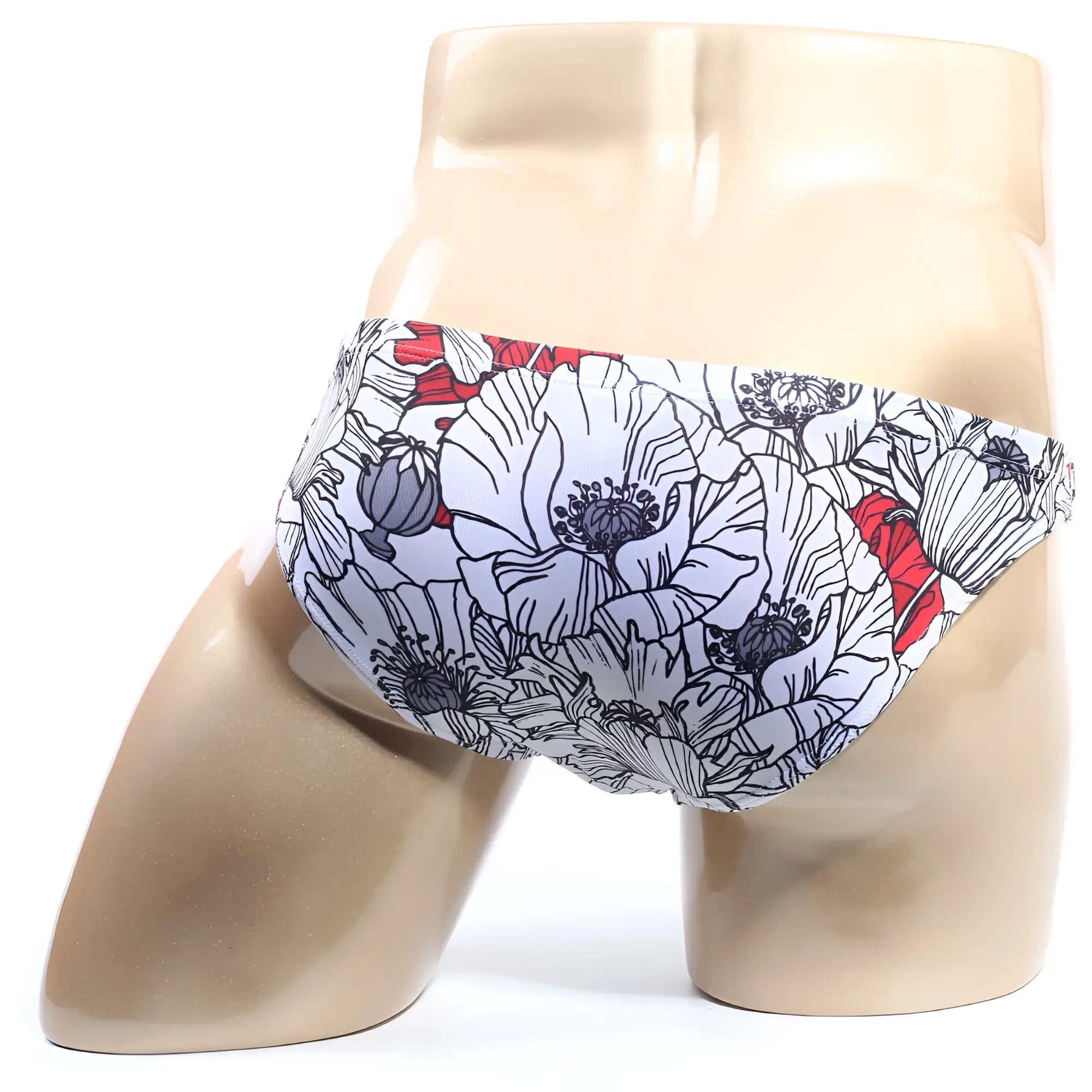 White swim trunks by metromalewear featuring bold floral pattern with black outlines and red accents for beachwear