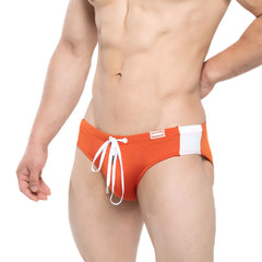 Orange MetroMaleWear Versity swim brief with white side panel and matching drawstring for beachwear or pool use