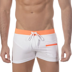White swim trunks with a bright orange waistband and zipper pocket featuring white drawstrings from MetroMaleWear