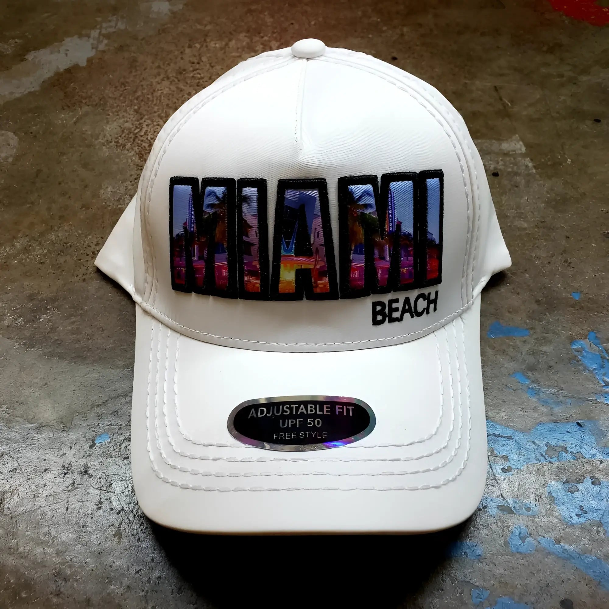 White baseball cap with vibrant colorful Miami Beach patch featuring urban skyline design and black trim
