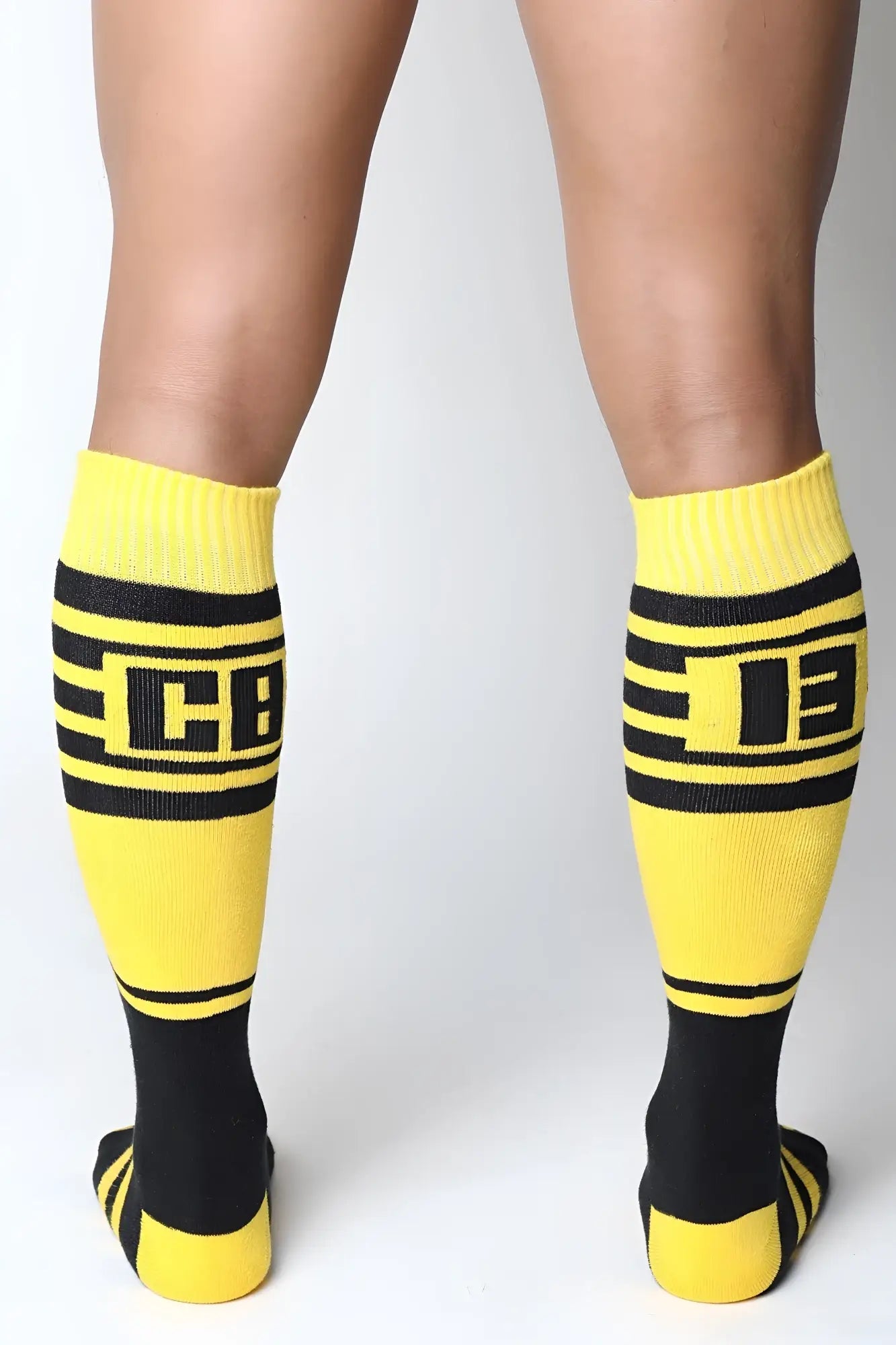 Bright yellow and black midfield knee high socks with bold horizontal stripes and a prominent cb logo center