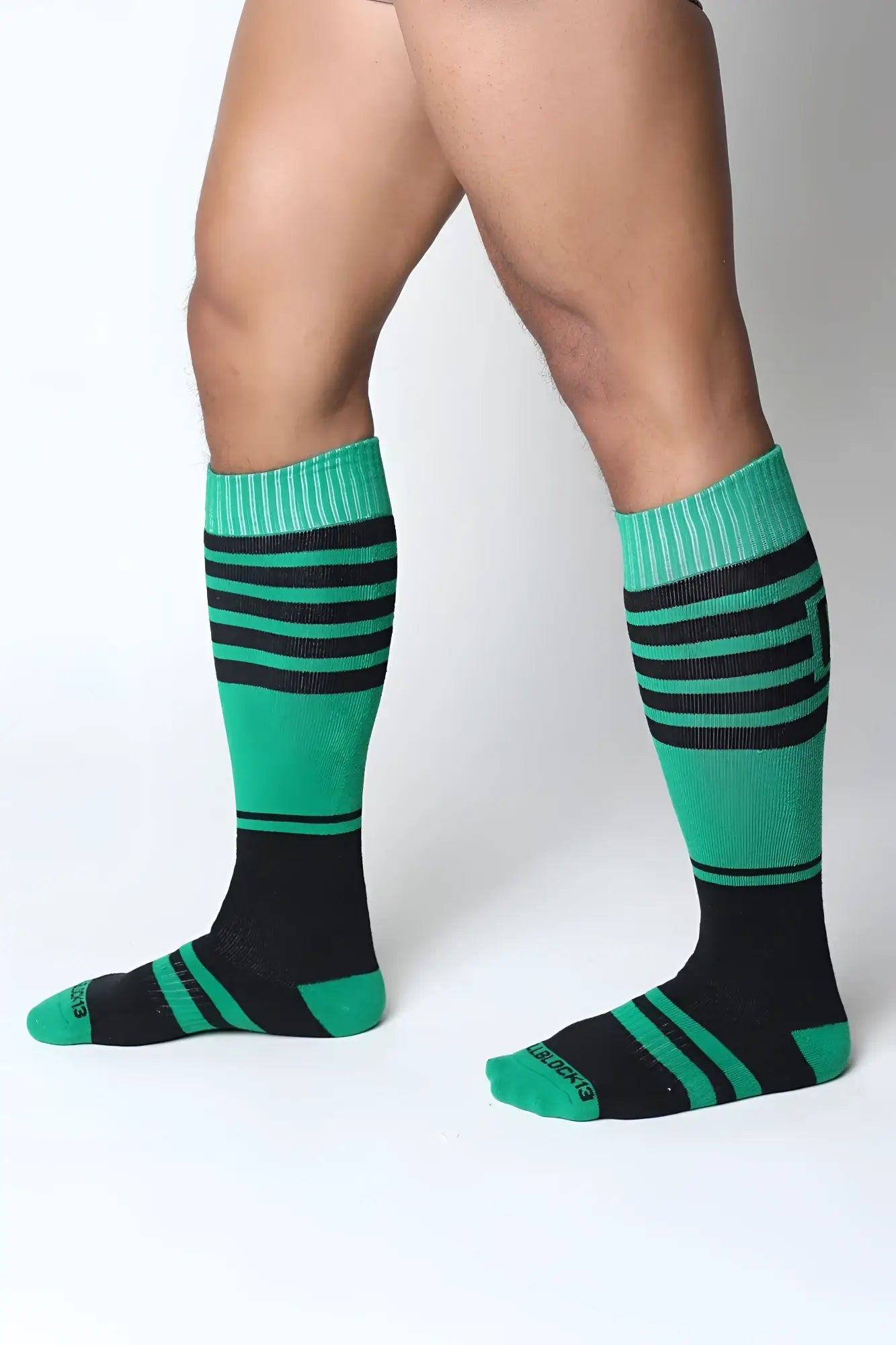 Midfield knee high sock in green and black stripes with ribbed cuffs made from soft breathable material