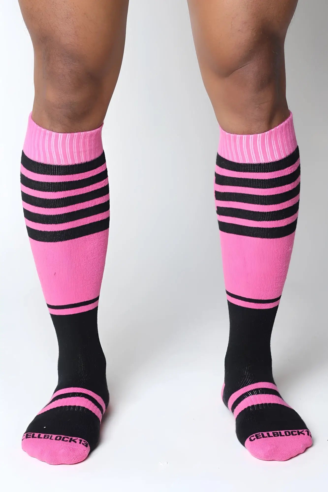 Midfield knee high socks in pink and black stripes with ribbed cuff and cellblock13 logo embroidered on the toe