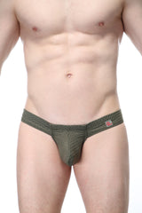 Olive green mesh thong with subtle textured pattern and small pink logo tag on waistband petitq mini boxer cheek bee sage
