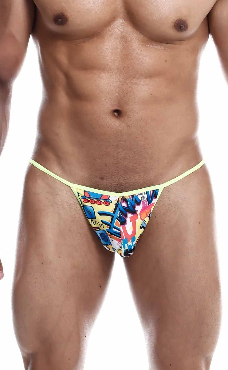 Bright yellow mob hipster t thong featuring vibrant graffiti print with colorful cartoon characters and bold lettering