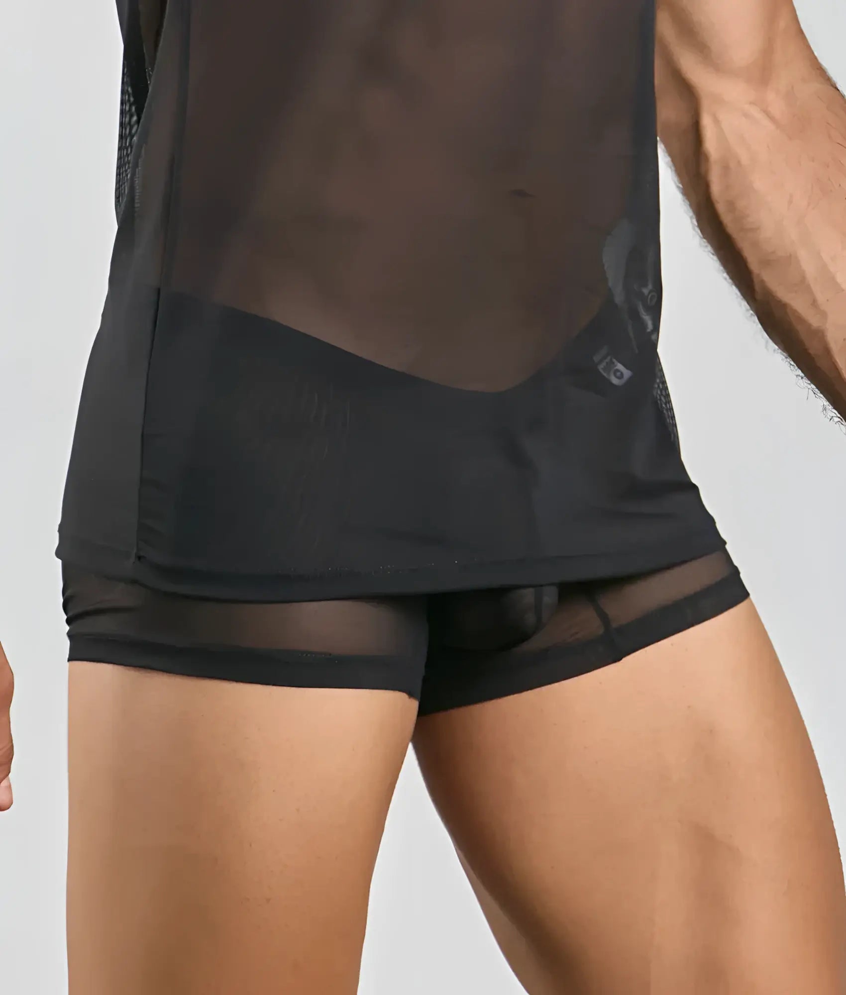 Black mesh athletic shorts with sheer form-fitting design and reinforced waistband shown from the back side