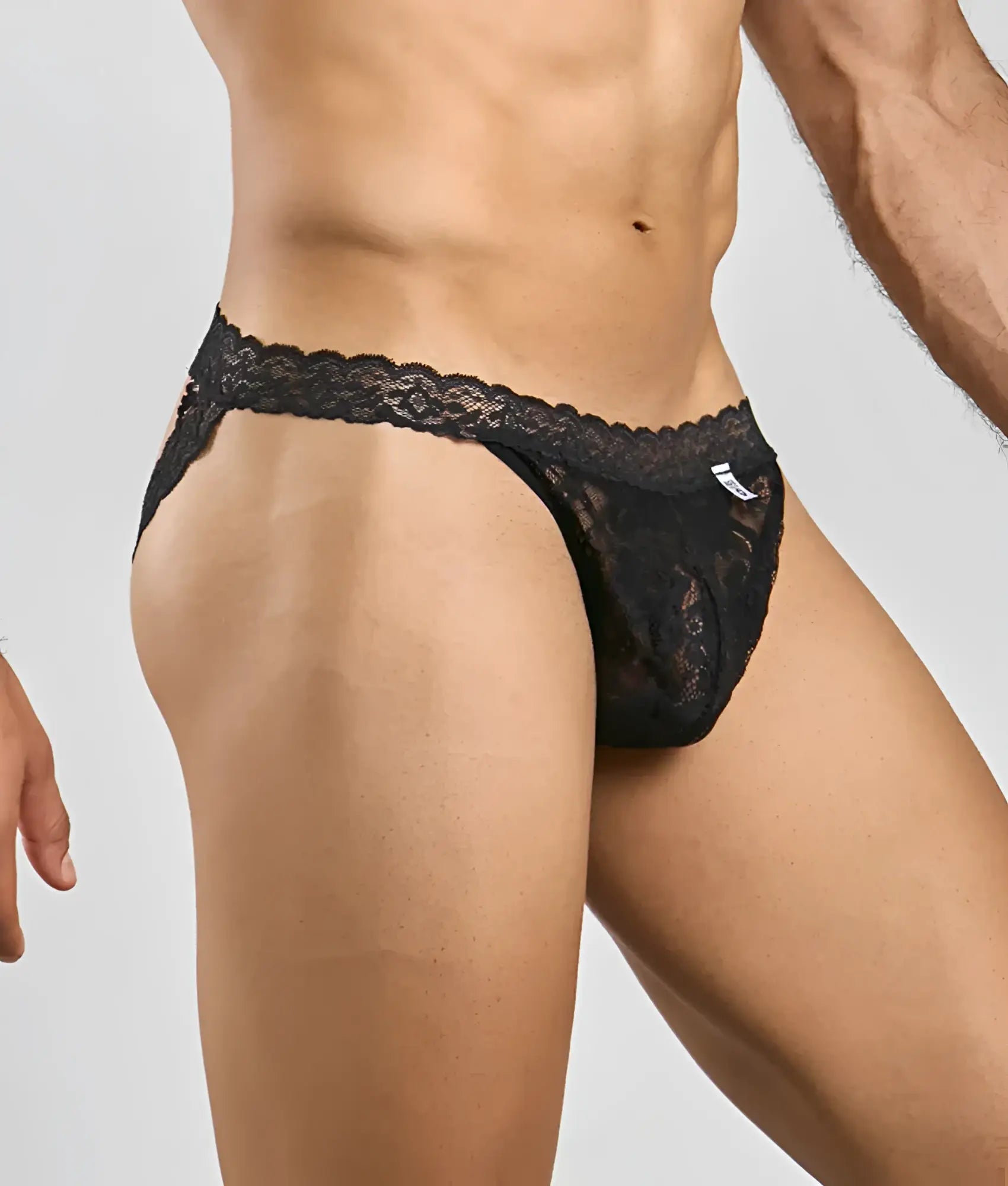 Black lace thong mob men’s lace jockstrap with intricate floral patterns and a delicate scalloped waistband