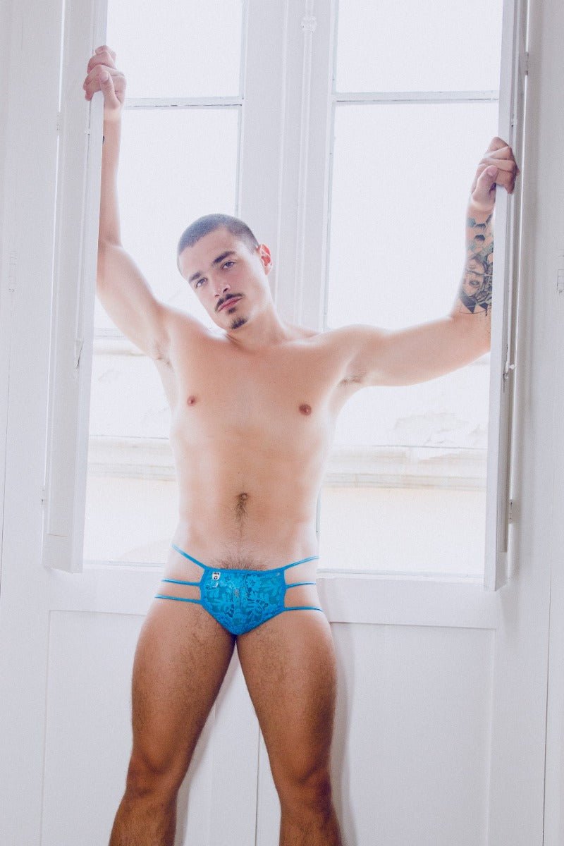 Mob men’s lace pouch thong in blue lace trimmed briefs with subtle pattern and thin side straps shown from the back